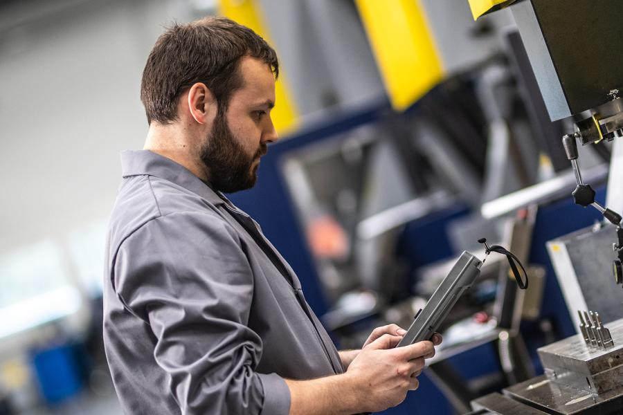 Engineer using digital screen in production