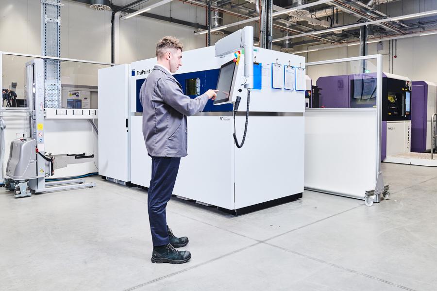 Engineer operating an additive machine